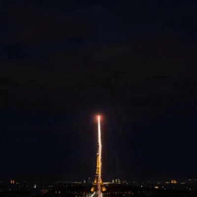 Fireworks light up Paris and reveal Happy New Year 2027 in golden letters above the Eiffel Tower.