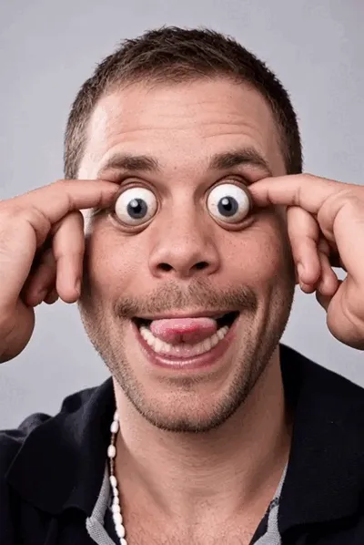A man pulls a funny face with moving eyes and his tongue out.