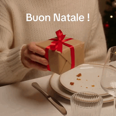 Un regalo con un fiocco rosso per augurare Buon Natale.