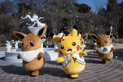 Pikachu and Eevee dance in a festive atmosphere.