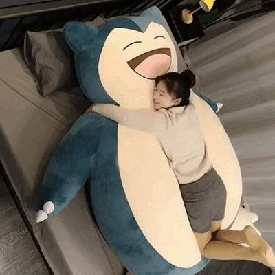 A big hug for a giant Snorlax plush toy.