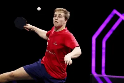 A table tennis player lands a spectacular smash.