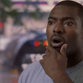 Wee-Bey opens his mouth in surprise and brings a hand to his face.